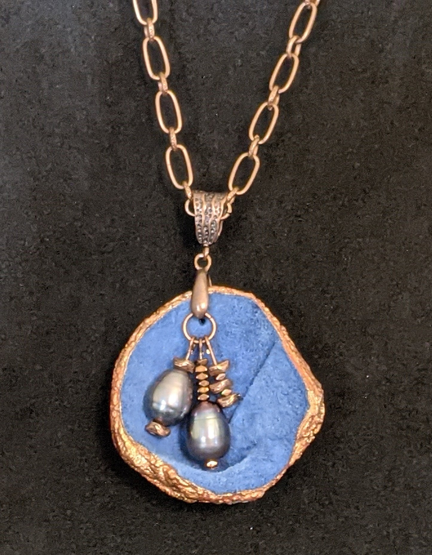 Blue leather pendant necklace with pearls and copper details