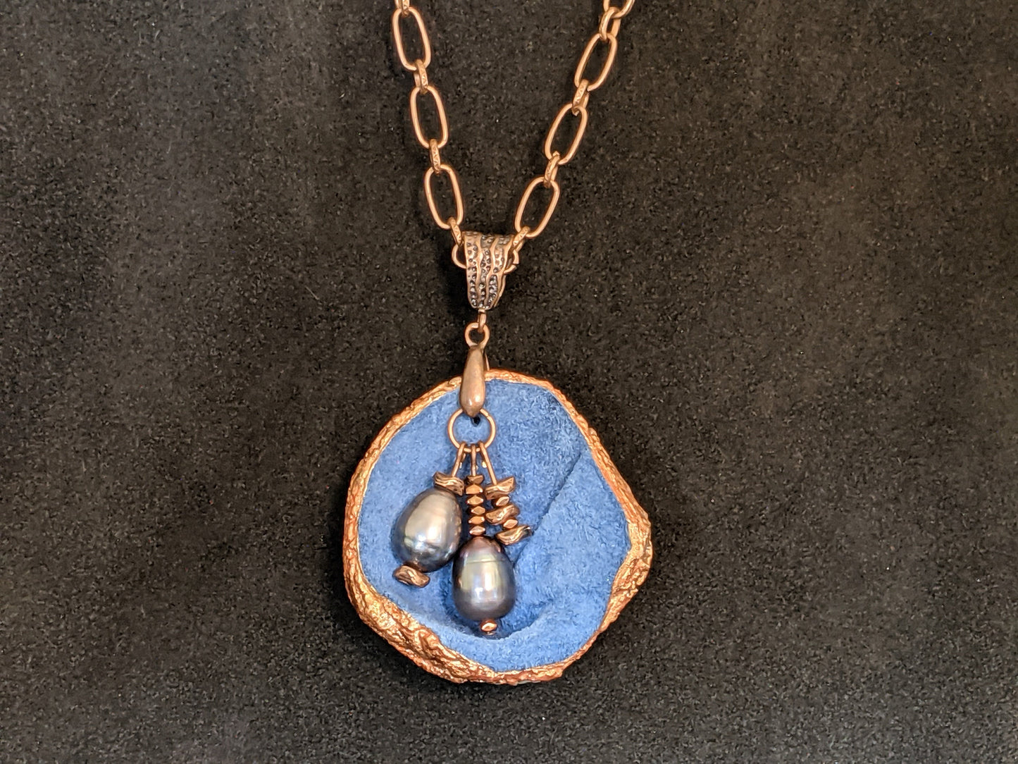 Blue leather pendant necklace with pearls and copper details