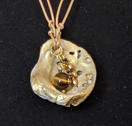 Pendant Necklace with leather cord and unique shell in gold and brown tones reversible